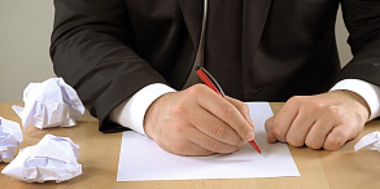 A man about to write a list of Goal Setting mistakes