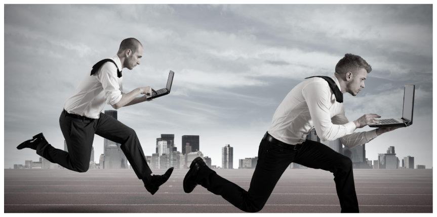 two business peope running a race with laptops in hand in suits