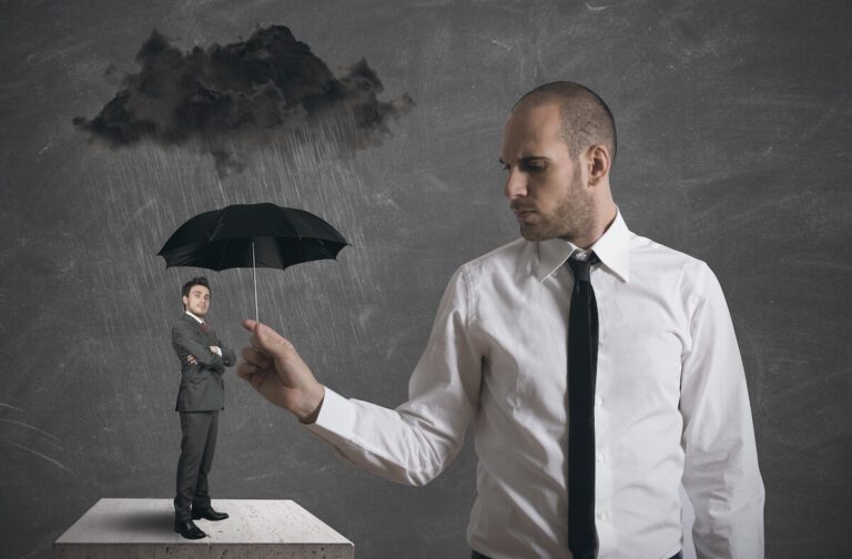 Man sheltering another man from the rain