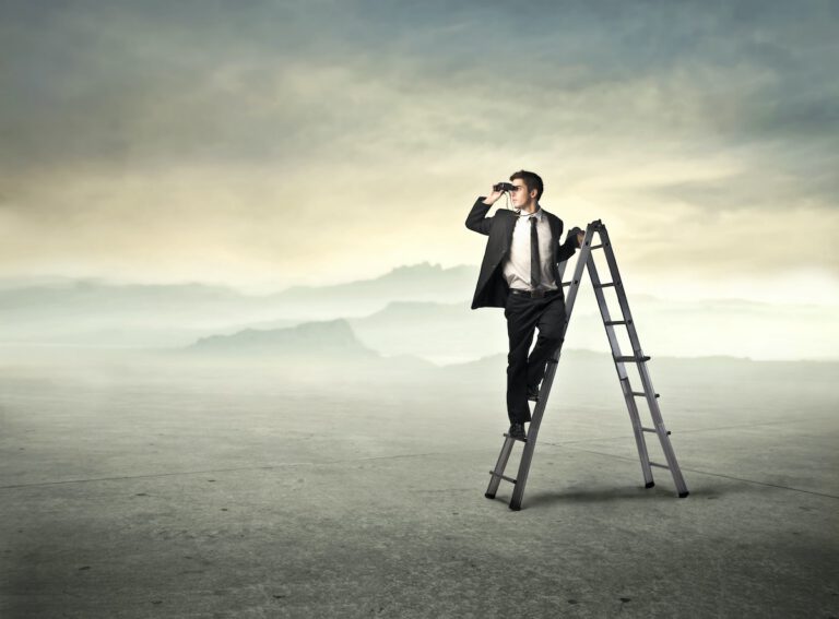 the future of work Businessman standing on a ladder and using binoculars