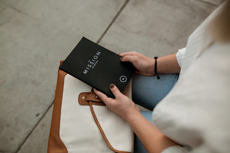 purpose at work person holding a journal with my mission written on the front