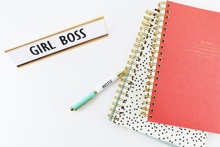 Girl boss name plate on work desk with books limiting yourself by focusing on job title