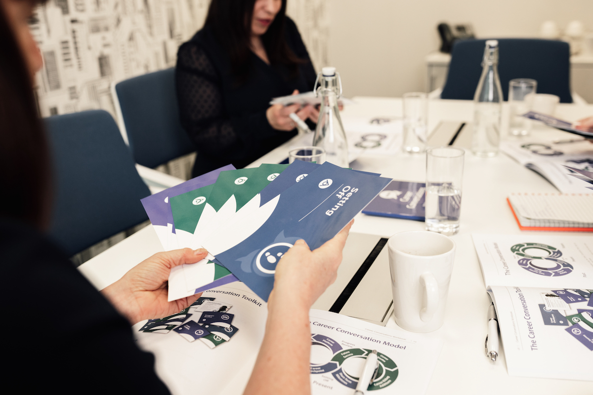 Career Conversations Workshop people with cards and workbooks in an office setting Antoinette Oglethorpe Ltd