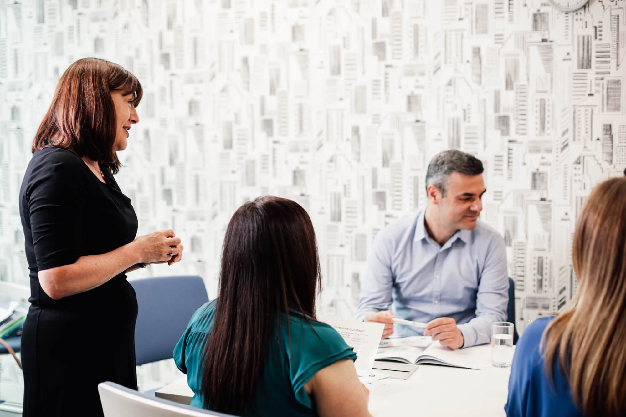 mentoring matching strategy - group of people in an office environment having a meeting