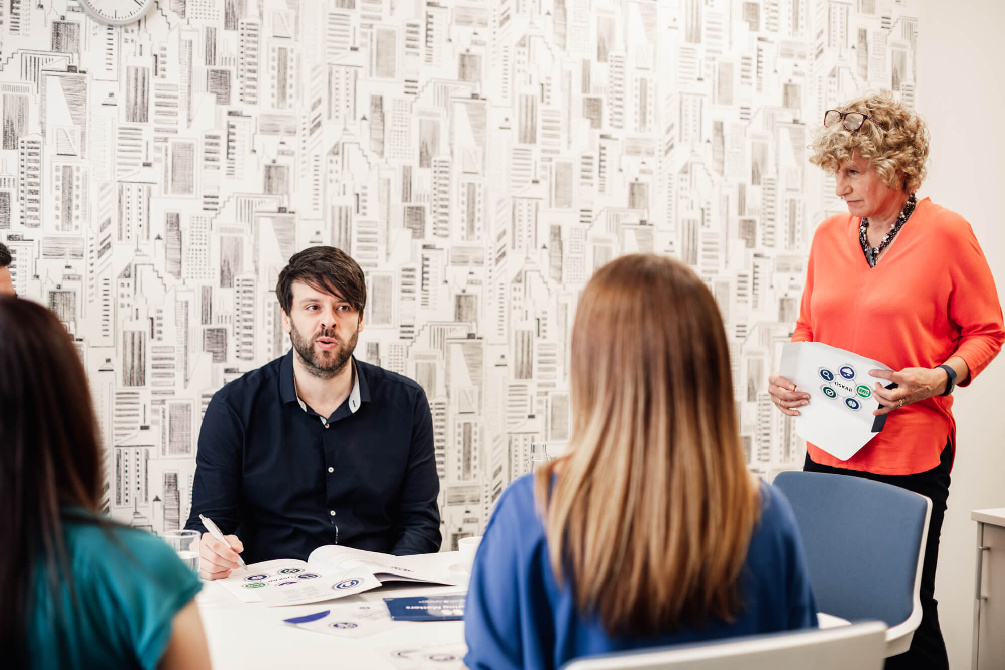 mentoring launch event people sat in a meeting in office environment