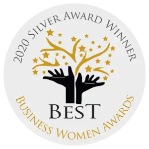 Circular badge with "2020 Silver Award Winner" at the top, "Business Women Awards" at the bottom, and two black hands holding gold stars and a tree in the centre with the word "Best" below.