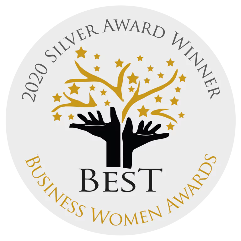 Circular badge with "2020 Silver Award Winner" at the top, "Business Women Awards" at the bottom, and two black hands holding gold stars and a tree in the centre with the word "Best" below.