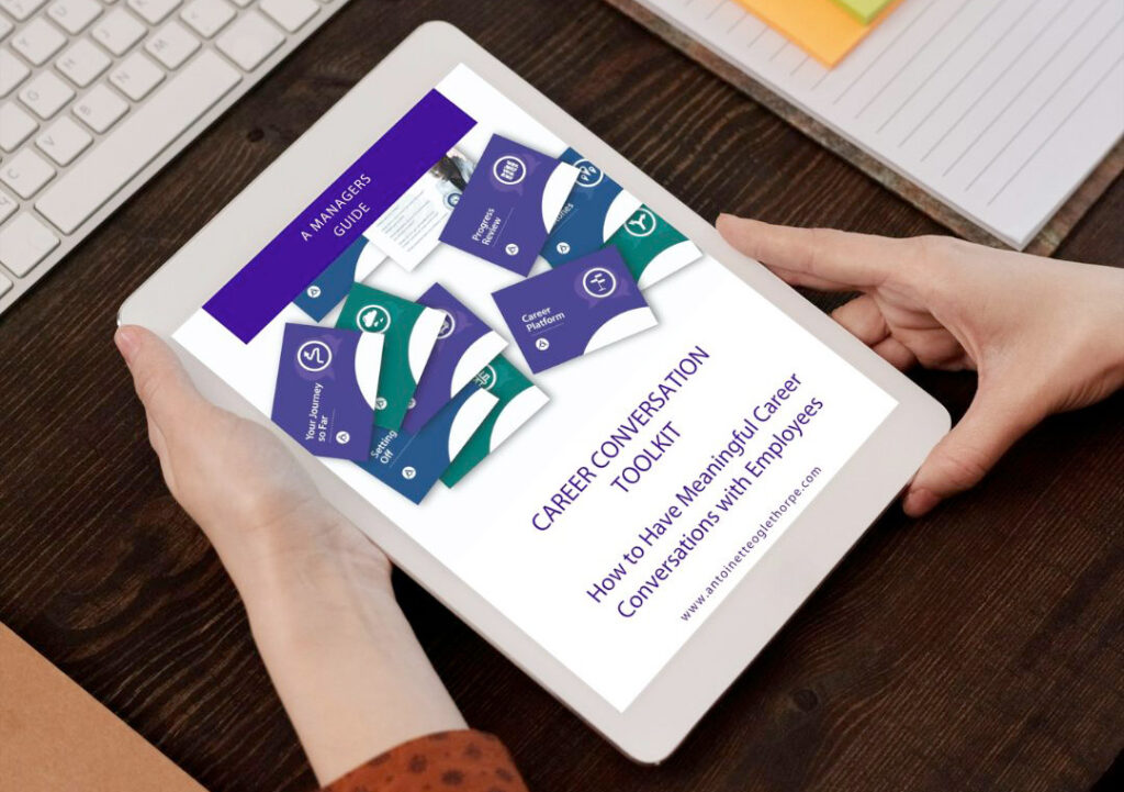 A managers guide to career conversations on an ipad being held by a person