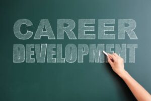 A hand holding chalk writes the words