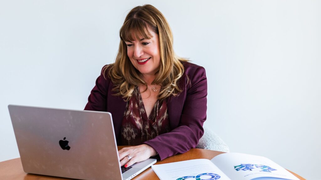 Antoinette working on a computer delivery a webinar